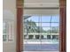Inviting patio view framed by elegant curtains, overlooking pool and lush landscaping at 7441 Myrica Dr, Sarasota, FL 34241