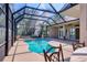 Screened-in pool area with a uniquely shaped pool, spa, and comfortable seating at 7441 Myrica Dr, Sarasota, FL 34241