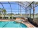 Enclosed pool with spa overlooking serene lake and landscaped golf course at 7441 Myrica Dr, Sarasota, FL 34241