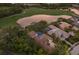A captivating aerial view of the beautiful home showcasing its private pool, stunning landscaping, and lake views at 7532 Greystone St, Lakewood Ranch, FL 34202