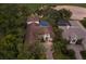Expansive aerial view of a luxurious home, showcasing a pool, lush landscaping, and a beautiful setting at 7532 Greystone St, Lakewood Ranch, FL 34202