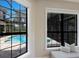 The two windows in the bedroom let in lots of light, while the swimming pool can be seen through the glass at 7532 Greystone St, Lakewood Ranch, FL 34202