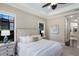 The bedroom is styled with a luxurious upholstered bed and views to the outside through multiple windows at 7532 Greystone St, Lakewood Ranch, FL 34202