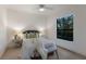 Well-lit bedroom with a comfortable bed, white furniture, and a window overlooking green scenery at 7532 Greystone St, Lakewood Ranch, FL 34202