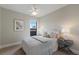 Cozy bedroom showcasing a comfortable bed, neutral tones, and a window for natural light at 7532 Greystone St, Lakewood Ranch, FL 34202