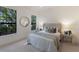Serene bedroom featuring a plush bed, soft colors, and large windows with garden views at 7532 Greystone St, Lakewood Ranch, FL 34202