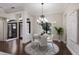 Elegant dining room featuring stylish chandelier, modern table set, and natural light from shuttered window at 7532 Greystone St, Lakewood Ranch, FL 34202