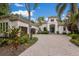 Inviting curb appeal with brick driveway, mature landscaping, and a desirable three-car garage at 7532 Greystone St, Lakewood Ranch, FL 34202