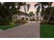 Stunning home featuring lush landscaping, brick driveway, and an inviting front entrance at 7532 Greystone St, Lakewood Ranch, FL 34202