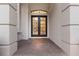Welcoming front entrance featuring a brick porch and beautiful double doors at 7532 Greystone St, Lakewood Ranch, FL 34202