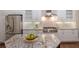 Bright kitchen boasts stainless steel appliances, custom cabinetry, and stone countertops perfect for culinary creations at 7532 Greystone St, Lakewood Ranch, FL 34202