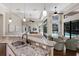 Open-concept kitchen with granite counters, stainless sink, and a view of the living space at 7532 Greystone St, Lakewood Ranch, FL 34202
