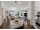 Open-concept kitchen with granite counters and stainless appliances seamlessly flows into living and dining areas at 7532 Greystone St, Lakewood Ranch, FL 34202