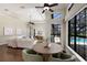 Bright living room featuring a modern ceiling fan, and a view of the pool at 7532 Greystone St, Lakewood Ranch, FL 34202