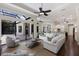 Bright living room with a sitting area, and views of the kitchen and pool area at 7532 Greystone St, Lakewood Ranch, FL 34202