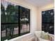 Bright living room featuring large windows offering scenic outdoor views and a stylish chair at 7532 Greystone St, Lakewood Ranch, FL 34202