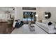 Inviting living room with neutral decor, hardwood floors, and a view of the outdoor pool at 7532 Greystone St, Lakewood Ranch, FL 34202