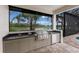 Outdoor kitchen with stainless steel grill and granite countertops at 7532 Greystone St, Lakewood Ranch, FL 34202