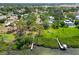 Aerial view of sprawling lawn and lush tropical foliage by the water's edge at 7620 Westmoreland Dr, Sarasota, FL 34243