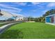 Lush green lawn and outdoor amphitheater with modern architectural design under a blue sky at 7620 Westmoreland Dr, Sarasota, FL 34243