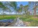 Landscaped backyard featuring a pathway to the water surrounded by mature trees at 7620 Westmoreland Dr, Sarasota, FL 34243