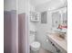 Clean bathroom with a vanity and a shower with gray and lavender curtain at 7620 Westmoreland Dr, Sarasota, FL 34243