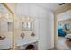 Well-lit bathroom with a built-in vanity, stool, and cabinet storage at 7620 Westmoreland Dr, Sarasota, FL 34243
