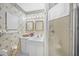 Classic bathroom featuring patterned wallpaper and a glass-enclosed shower at 7620 Westmoreland Dr, Sarasota, FL 34243