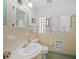 Bathroom featuring a white sink, toilet, and vintage yellow and green tiling at 7620 Westmoreland Dr, Sarasota, FL 34243