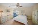 Serene bedroom featuring tiled floors, white linens, and scenic water views at 7620 Westmoreland Dr, Sarasota, FL 34243