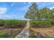 View of the water showing a wooden boardwalk through lush vegetation with a glimpse of the bay beyond at 7620 Westmoreland Dr, Sarasota, FL 34243