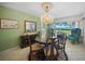 Elegant dining room with chandelier, water view, and classic furnishings at 7620 Westmoreland Dr, Sarasota, FL 34243
