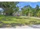 Beautiful lawn and treed expanse leading up to the home and the bay at 7620 Westmoreland Dr, Sarasota, FL 34243