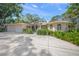 Front exterior of the home, featuring an attached garage and mature landscaping at 7620 Westmoreland Dr, Sarasota, FL 34243