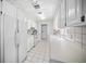 Bright kitchen with white cabinetry, appliances, and adjacent laundry room at 7620 Westmoreland Dr, Sarasota, FL 34243