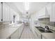 Spacious kitchen with white cabinets, appliances, and views to adjacent nook at 7620 Westmoreland Dr, Sarasota, FL 34243