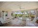 Enclosed patio with outdoor dining set and views of landscaped lawn and waterfront at 7620 Westmoreland Dr, Sarasota, FL 34243