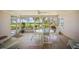 Enclosed patio with outdoor dining set and views of landscaped lawn and waterfront at 7620 Westmoreland Dr, Sarasota, FL 34243