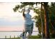 Outdoor view of a classical statue of a Roman figure pointing, near trees and waterfront at 7620 Westmoreland Dr, Sarasota, FL 34243