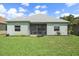 A serene backyard features lush green grass, landscaping, and a screened-in lanai for outdoor relaxation at 7743 Ridgelake Cir, Bradenton, FL 34203