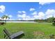 Lush backyard features manicured lawn, chaise lounge and serene lake views at 7743 Ridgelake Cir, Bradenton, FL 34203