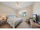 Comfortable bedroom features a decorative bed frame, view to outside and sitting area at 7743 Ridgelake Cir, Bradenton, FL 34203