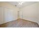 Neutral bedroom with ceiling fan, carpeted floors, and closet space at 7743 Ridgelake Cir, Bradenton, FL 34203