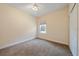 Neutral-toned carpeted bedroom with a ceiling fan and window, offering natural light at 7743 Ridgelake Cir, Bradenton, FL 34203