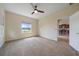 Spacious carpeted bedroom with a ceiling fan and views of the lake at 7743 Ridgelake Cir, Bradenton, FL 34203