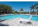 Resort-style community pool with lounge chairs, palm trees, and a glimpse of neighborhood homes at 7743 Ridgelake Cir, Bradenton, FL 34203