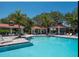 Expansive community pool with multiple covered lounge areas and mature palm trees at 7743 Ridgelake Cir, Bradenton, FL 34203
