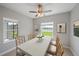 Bright dining room features stylish decor, ceiling fan, and a picturesque view of the outdoors at 7743 Ridgelake Cir, Bradenton, FL 34203