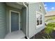 Close-up of a modern front door with white trim and a nearby window at 7743 Ridgelake Cir, Bradenton, FL 34203