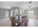 Spacious kitchen island with a sink, granite countertop, stylish pendant lights, and a view of the lake at 7743 Ridgelake Cir, Bradenton, FL 34203